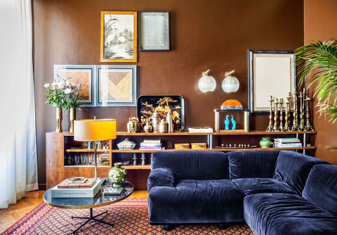 living room with blue sofa and antique candlesticks behind