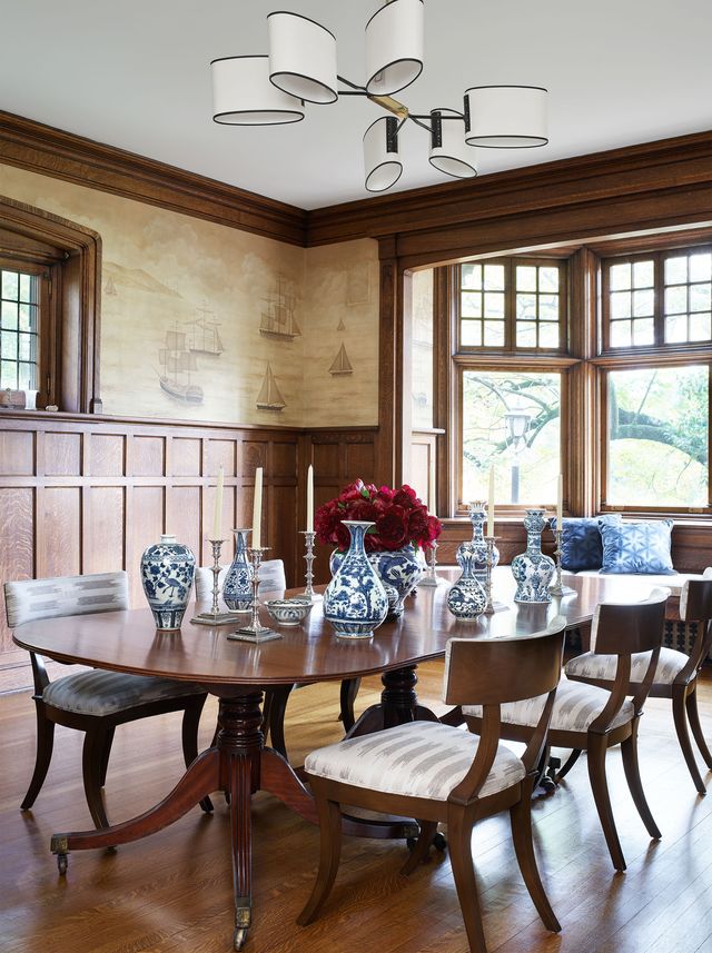 dining room with wood table, wainscoting and doors open to outside
