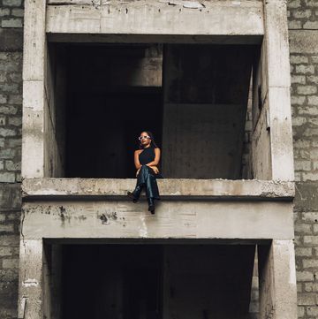 woman sitting in the middle of a construction site