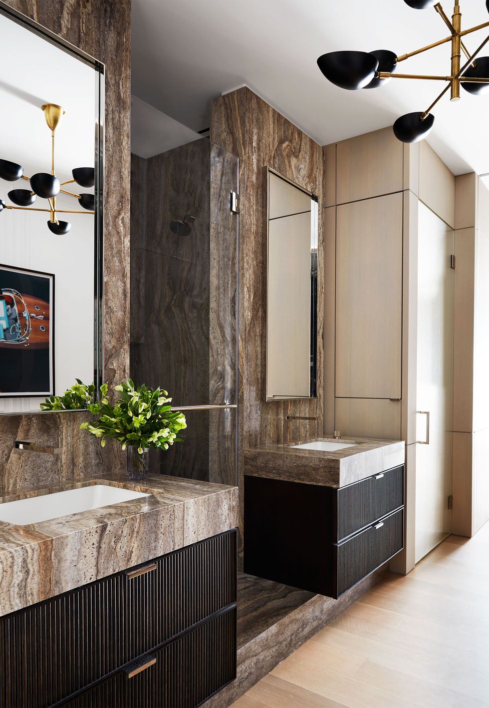 bathroom with matching floating vanities with brownish marble travertine sinks and wall behind and brown drawers beneath and simple mirrors above