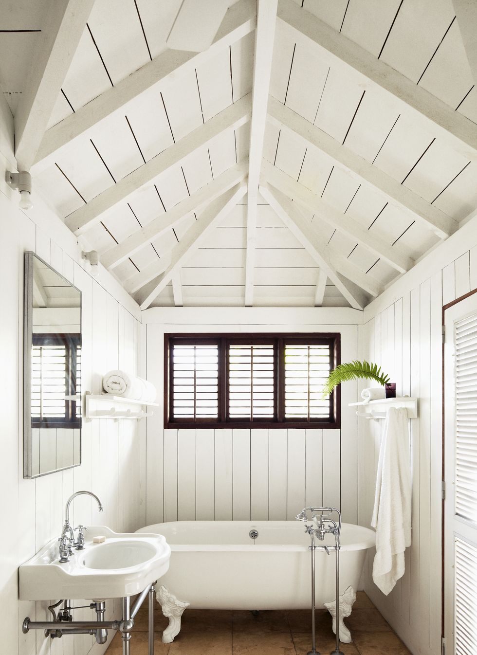 bathroom with white tub and canopy