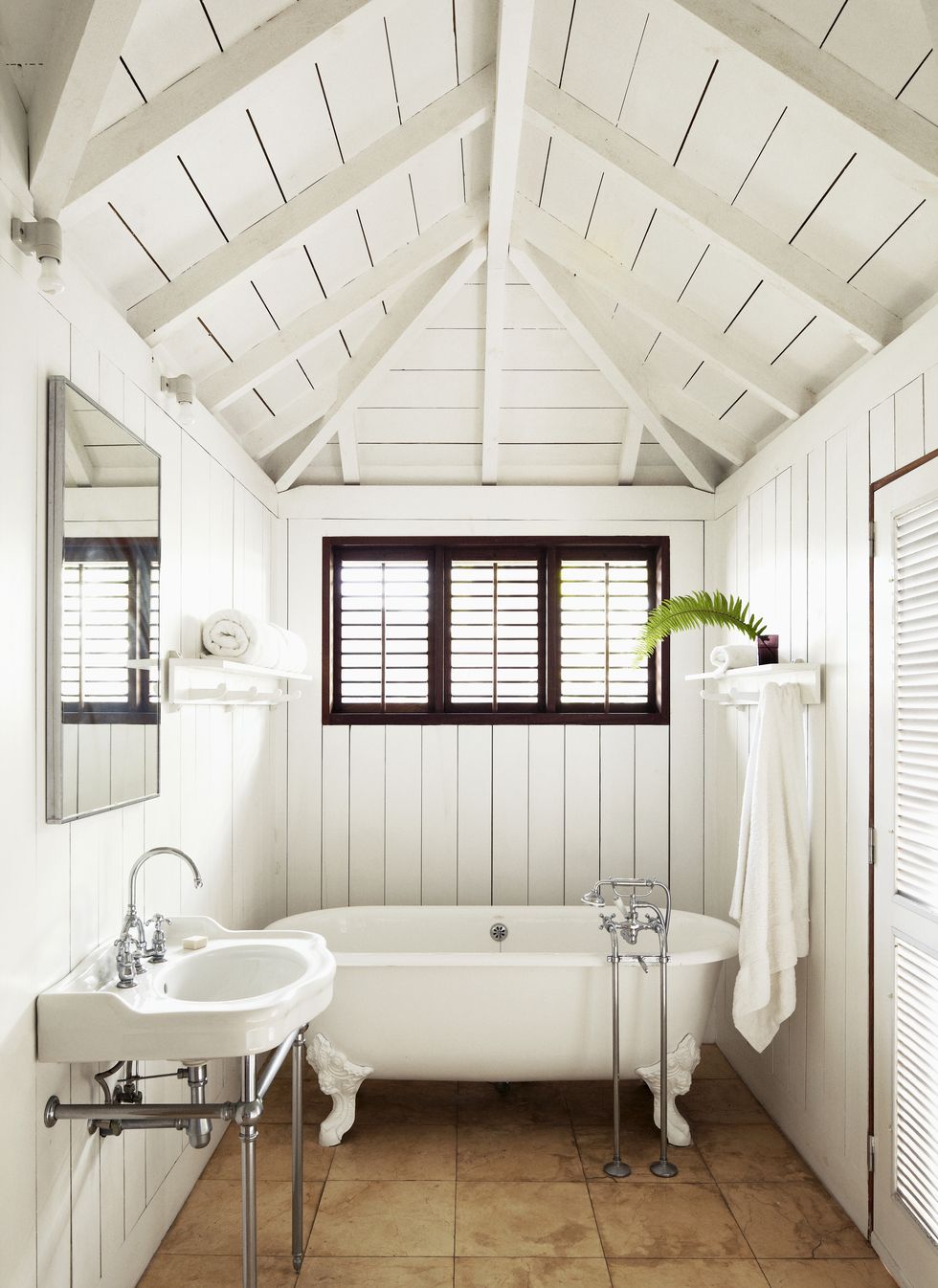 bathroom with white tub and canopy