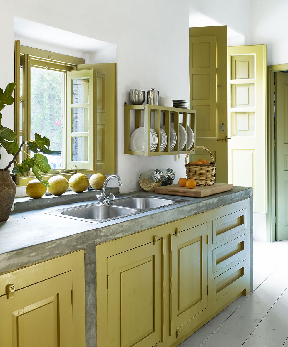 simple kitchen cabinets painted in a chartreuse color and matching window and door frames