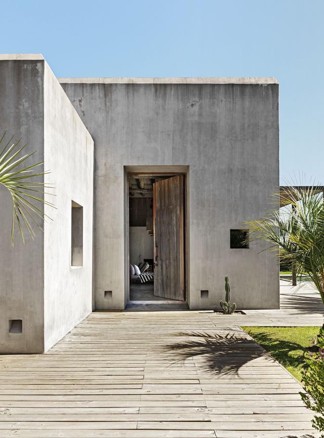Architect Diego Montero designed the concrete hacienda. The front door is recycled lapacho wood, and the deck is eucalyptus.