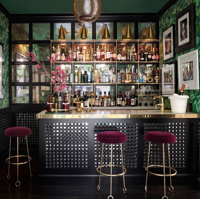 bar with  leafy wallpaper and jean royère ﻿barstools