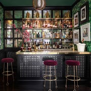 Home Bars - ELLE Decor home bar with gold counter and red velvet seats