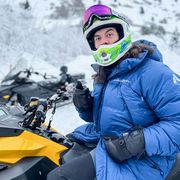 riding a snowmobile in eddie bauer alpine parker