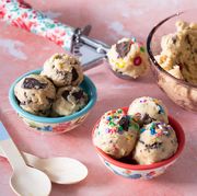 edible cookie dough in scoops with two bowls in front and big bowl in back