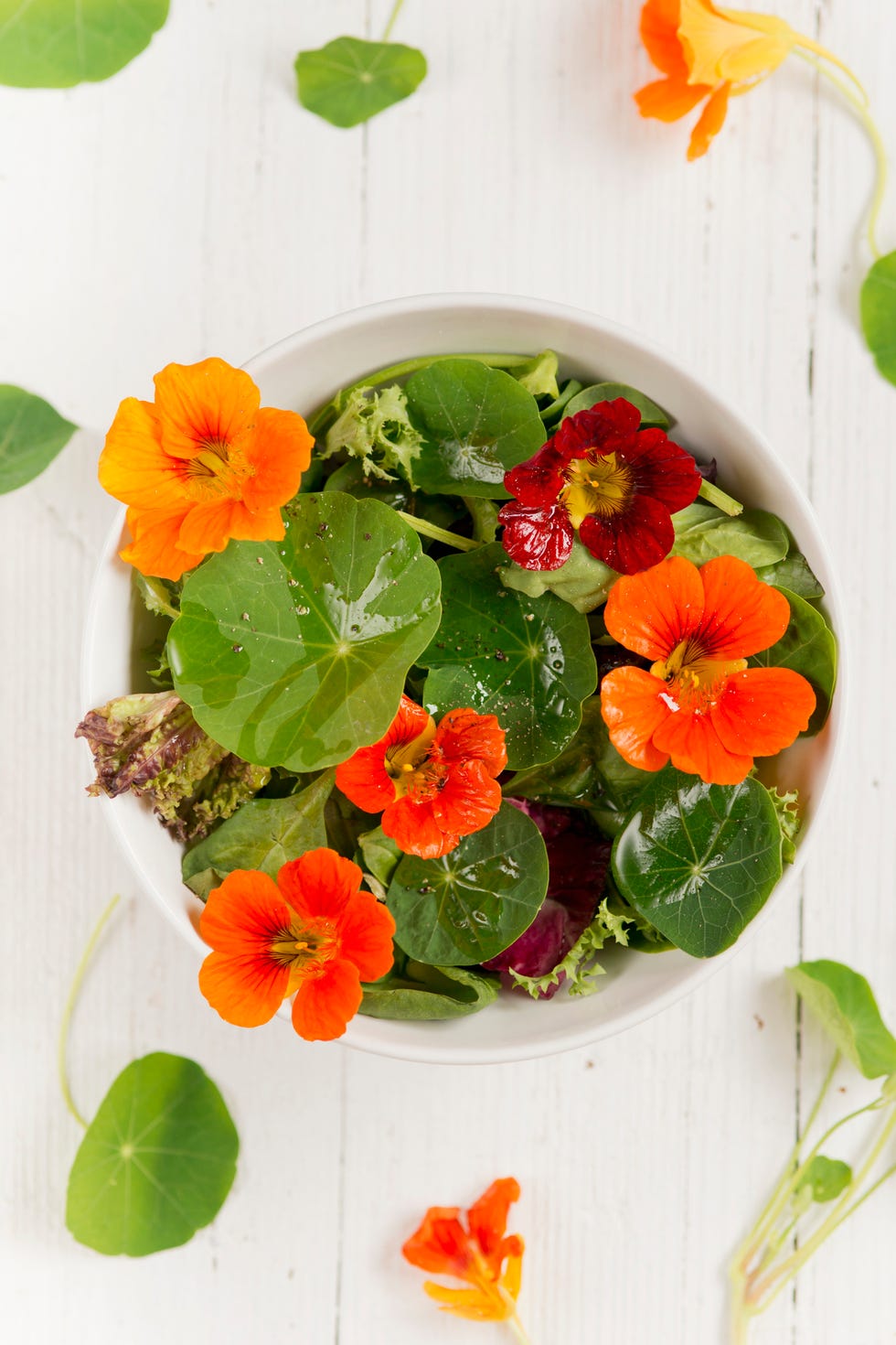 a colourful salad with watercress flowers and leaves and edible flowers