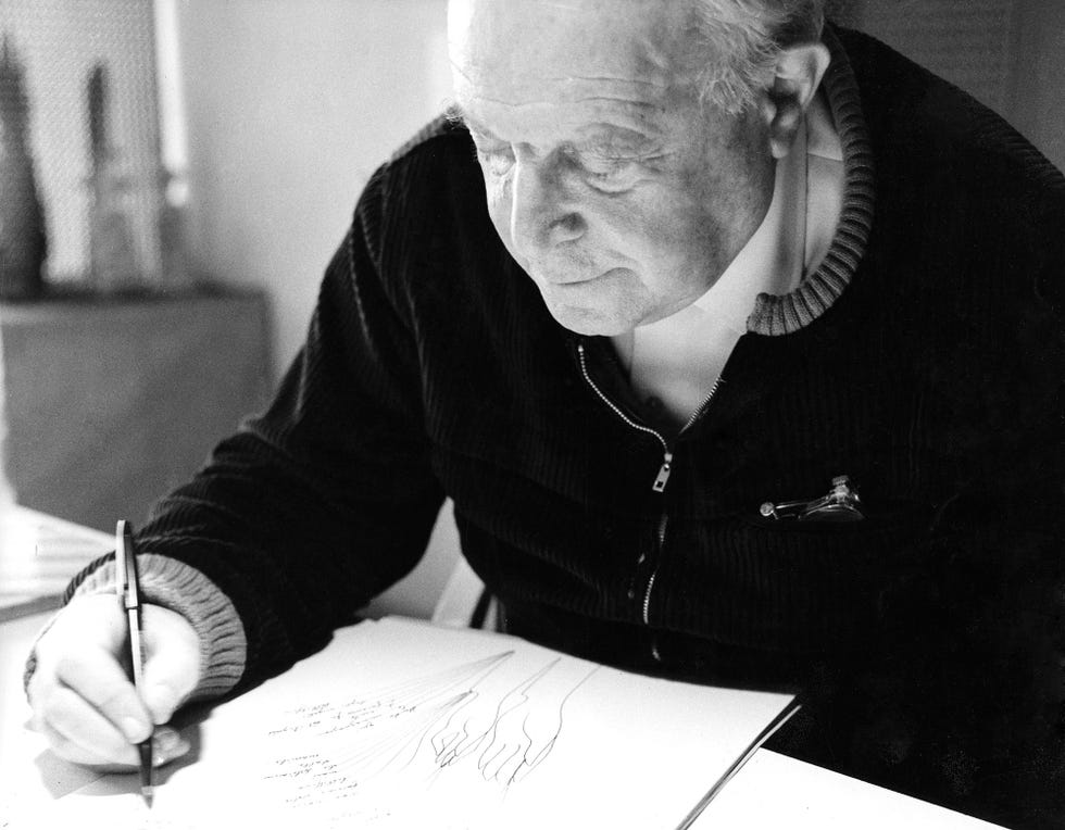 a person drawing in a sketchbook