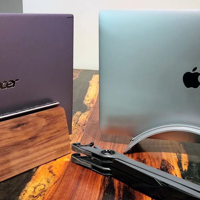 laptop stands holding up an acer laptop and a macbook