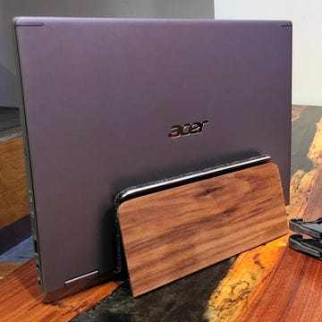 laptop stands holding up an acer laptop and a macbook