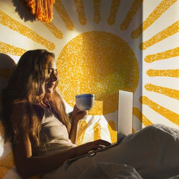 woman watching movie in bed