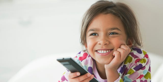 Mixed race girl watching television