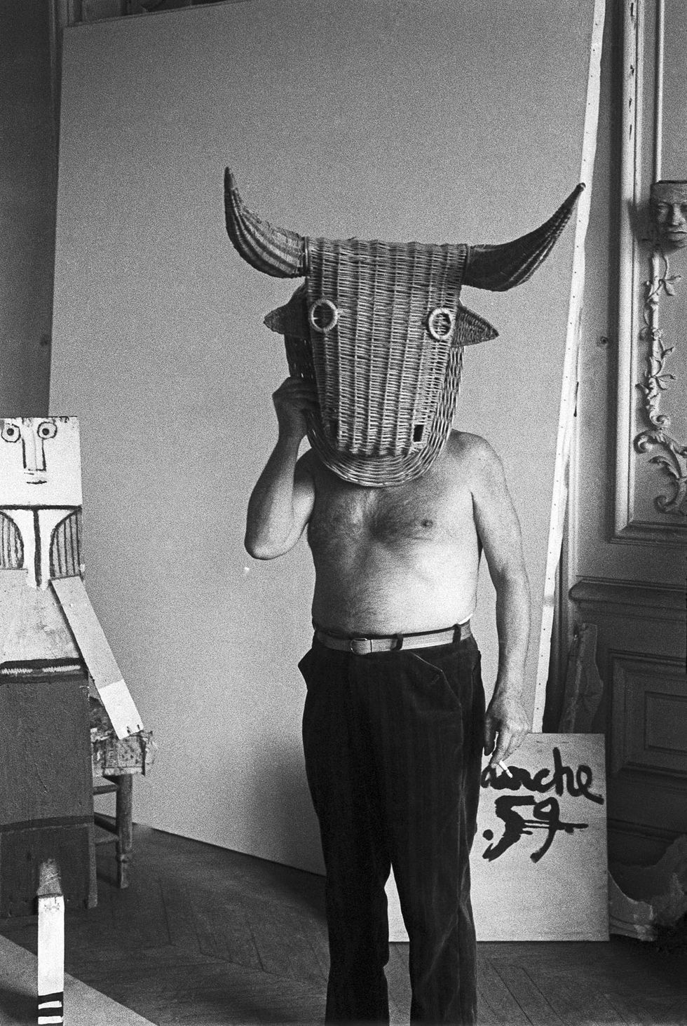 pablo picasso with a wicker bull mask originally intended for bullfighters' training, he becomes a living minotaur beside him is a sculpture made of scrap wood with the features painted on it la californie, cannes 1959