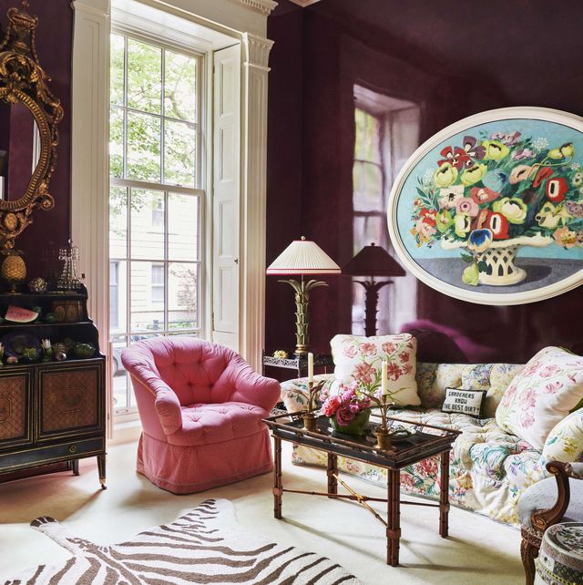the aubergine living room is part of the familys private quarters and it has a glazed wall finish and zebra pattern rug