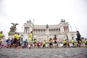 a group of people running in front of a white building