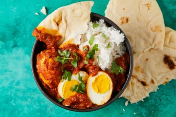 egg curry with naan and rice