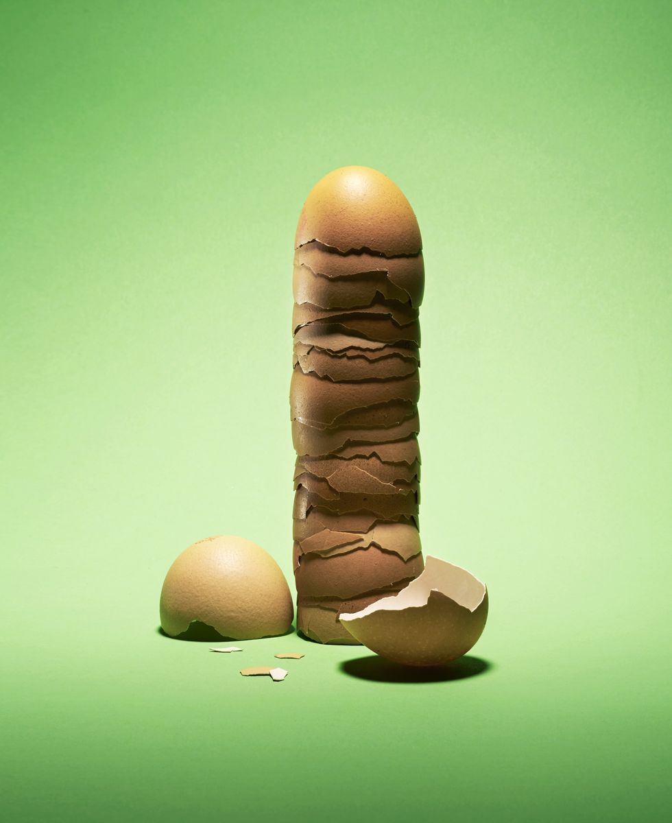 a tower of half egg shells stacked with two halves strategically placed to resemble a penis and testicles
