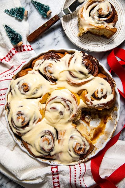 brown butter eggnog cinnamon rolls with red ribbon on side