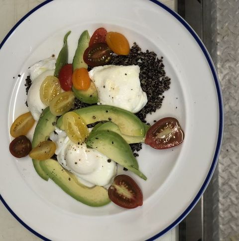 poached eggs, quinoa, tomatoes, and avocado on plate