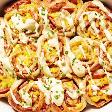 pinwheel style rolls baked in a casserole dish and topped with hollandaise