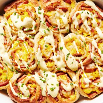 pinwheel style rolls baked in a casserole dish and topped with hollandaise