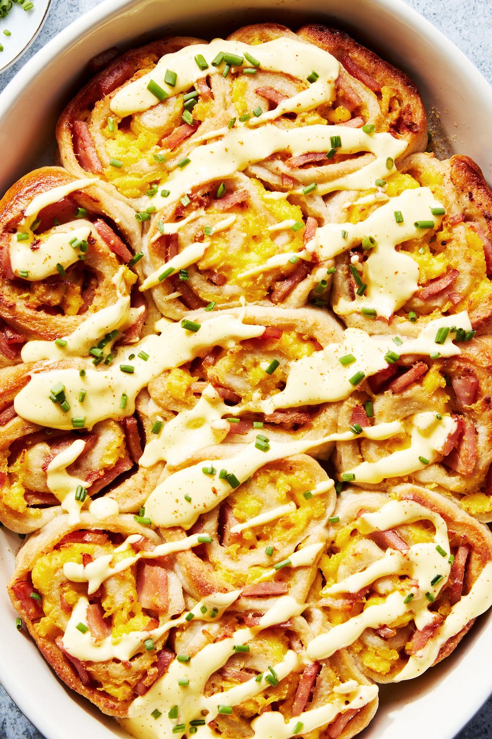 Eggs Benedict Rolls pinwheel style rolls baked in a casserole dish and topped with hollandaise