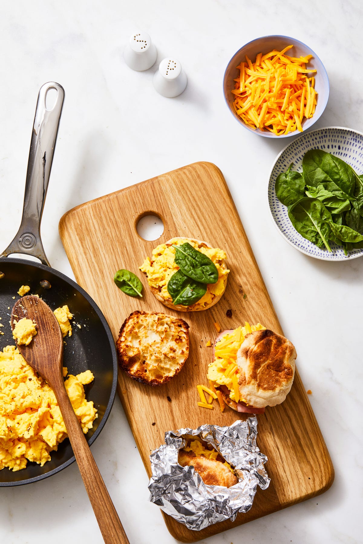 egg and cheese sandwiches on a wooden cutting board
