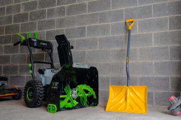 ego electric snowblower next to snow shovel in garage