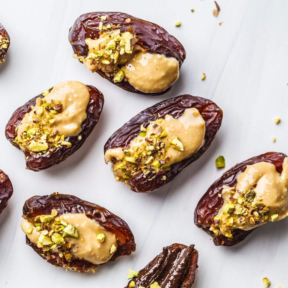 eid al fitr food dates stuffed with peanut butter and pistachios on a white background