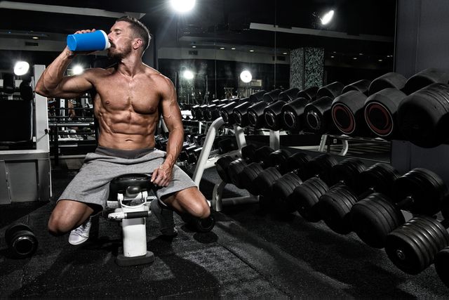 Man in the gym drinking protein shake drink