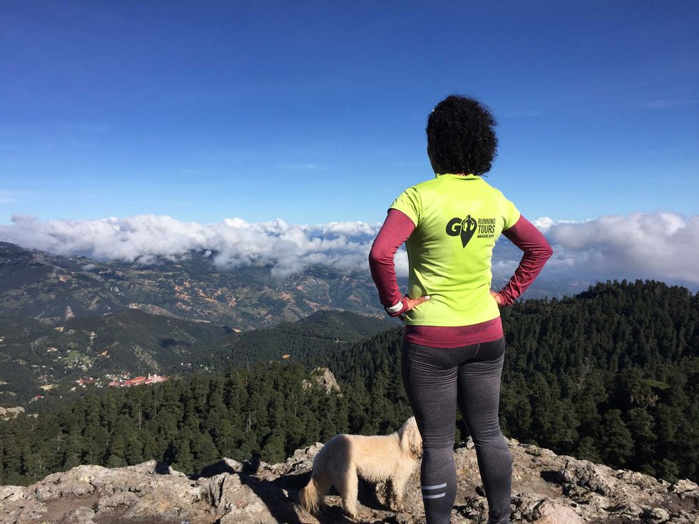 Runner pauses at a scenic lookout on the El Chico trail