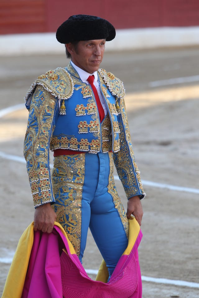 Matador, Bullfighting, Performance, Tradition, Public event, Sport venue, Animal sports, Outerwear, Event, Bullring, 