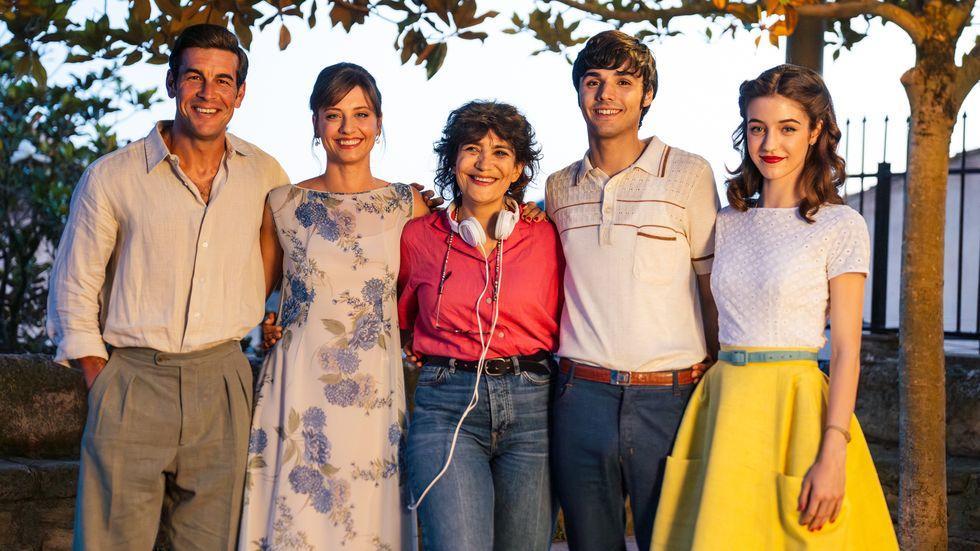 group of five individuals standing together outdoors