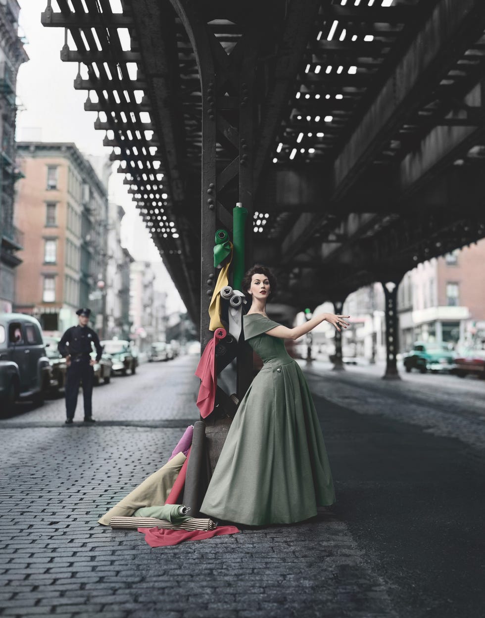 american model dovima posing in a christian dior dress with rolls of fabric, under the elevated railway, 3rd avenue, new york, 1956 for 'dior creates cosmopolitan drama' photo by william helburncorbis via getty images