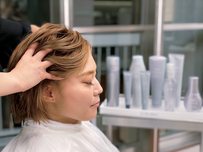 a woman with her hair in a ponytail