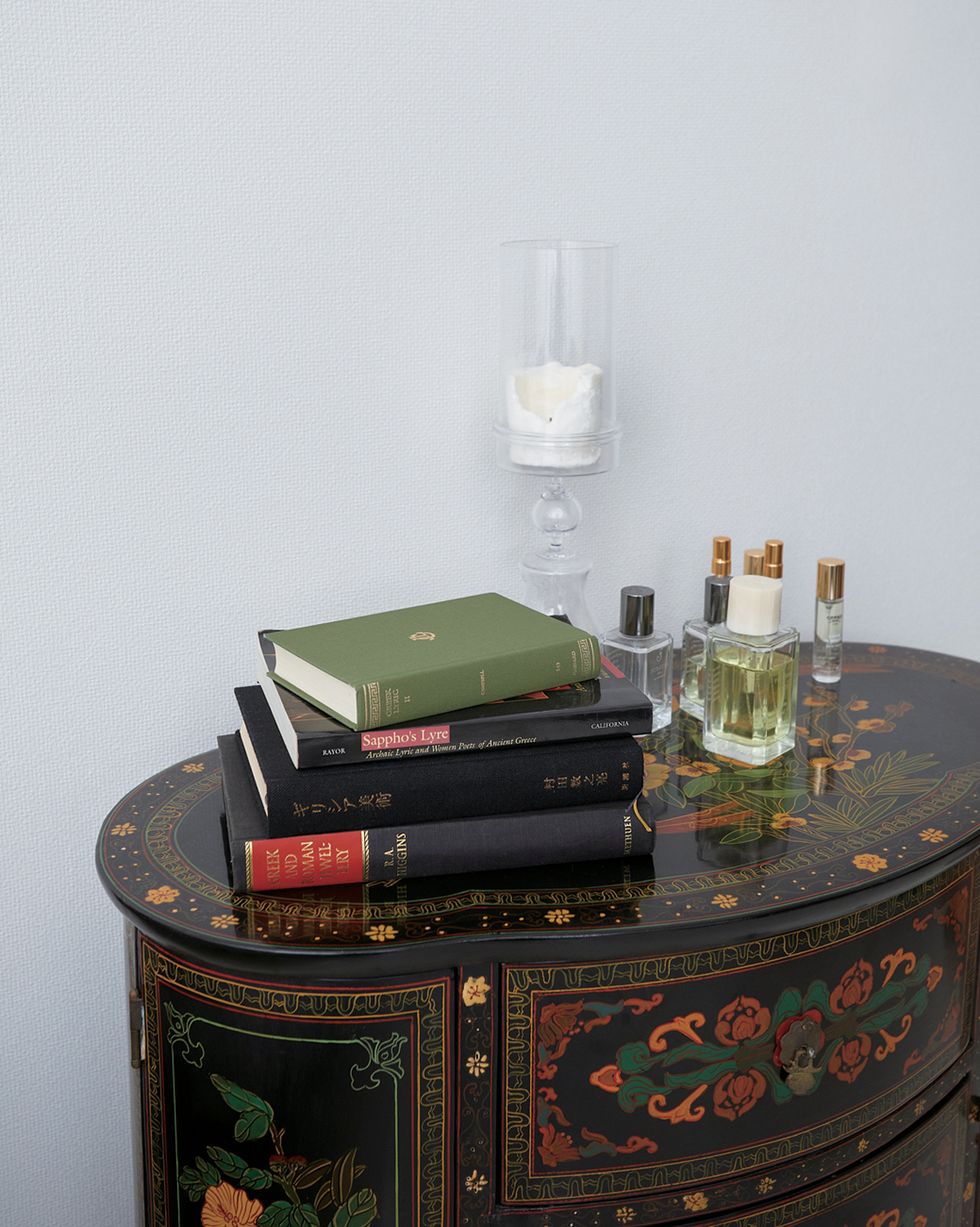 a stack of books and a glass on a table