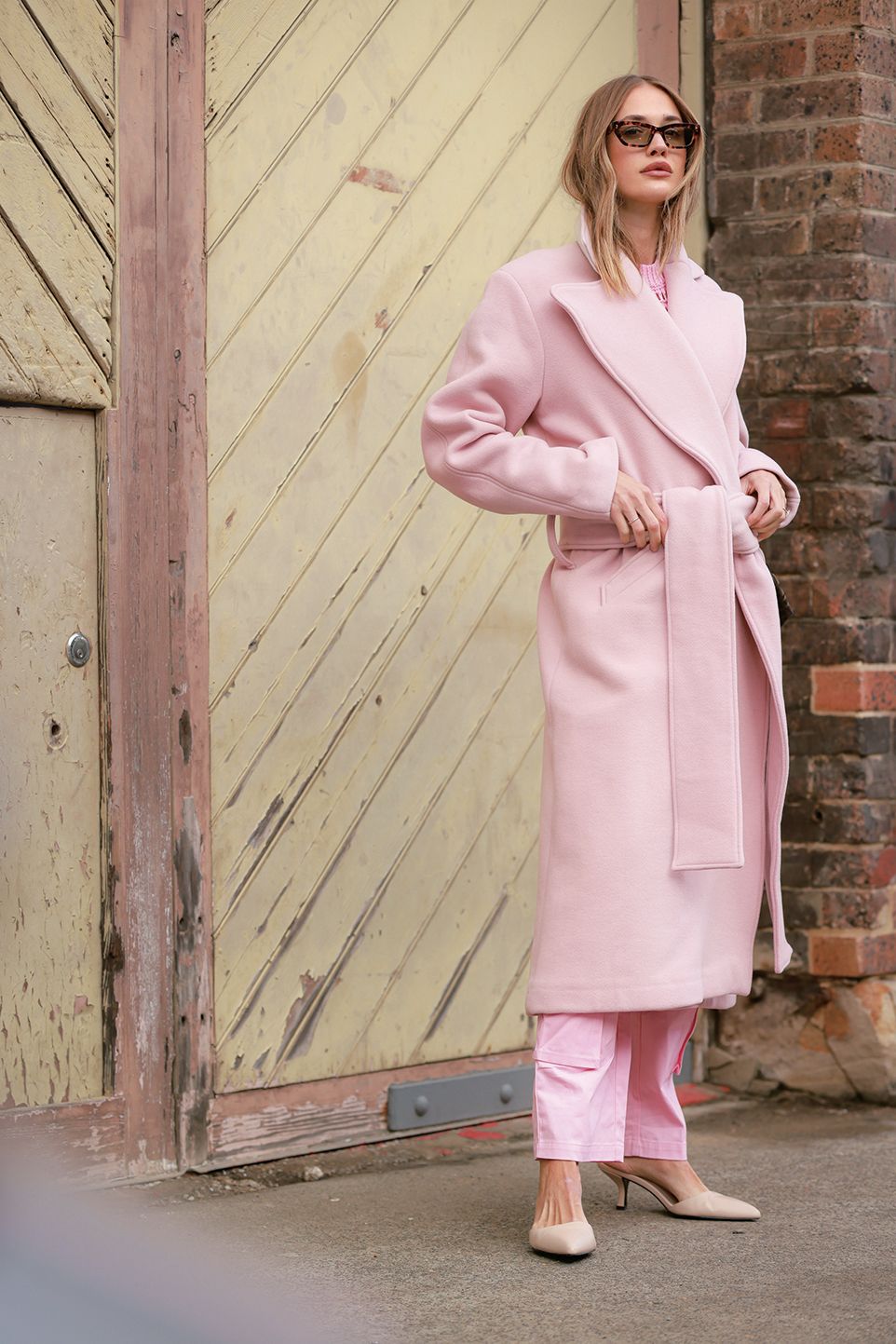 sydney, australia may 18 a guest wearing pink coat and pink pants at afterpay australian fashion week 2023 at carriageworks on may 18, 2023 in sydney, australia photo by hanna lassengetty images