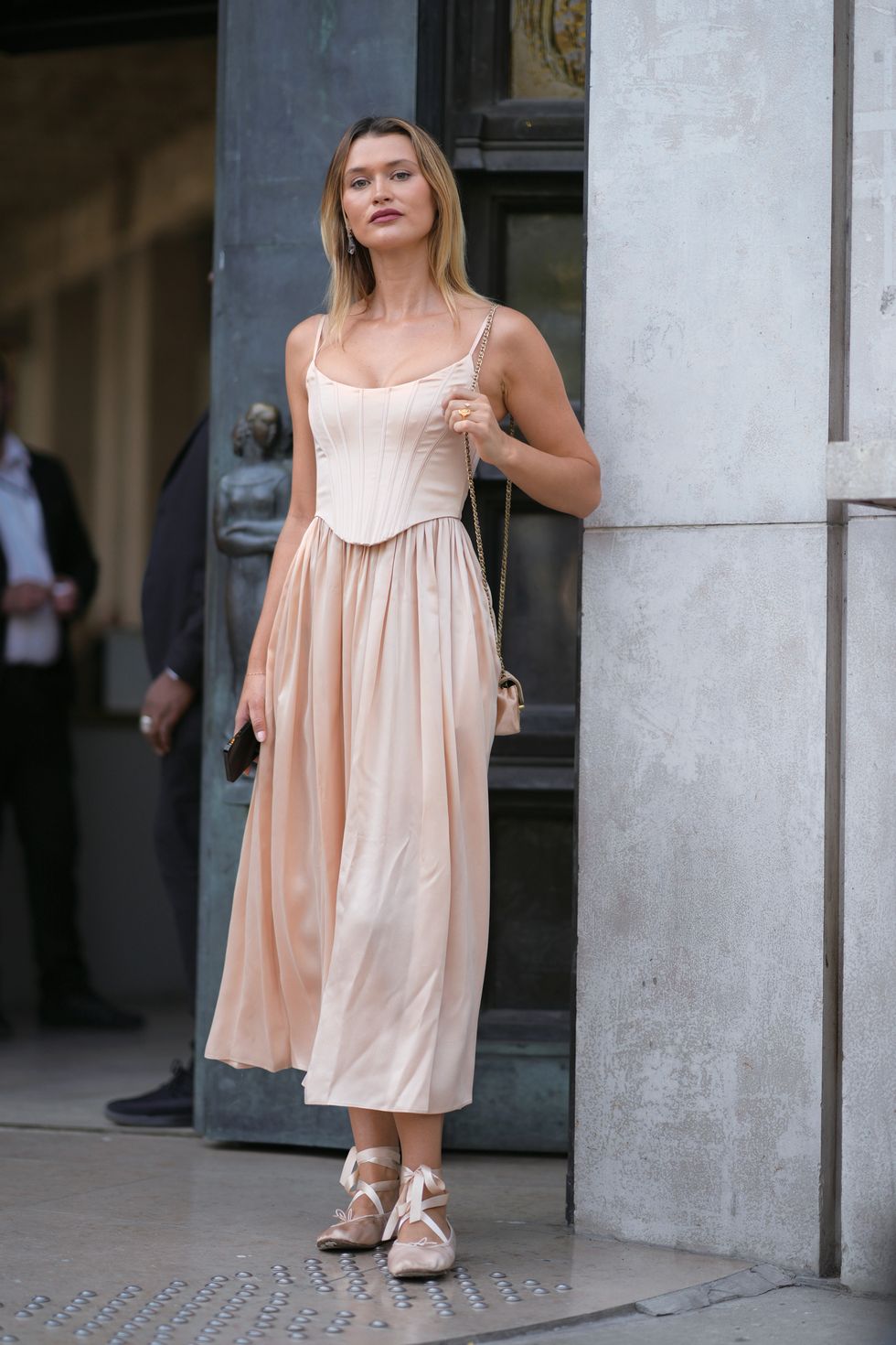 paris, france october 02 a guest wears a corset top in white, a pastel pale pink gathered midi skirt, ballerina shoes, outside zimmermann, during the womenswear springsummer 2024 as part of paris fashion week on october 02, 2023 in paris, france photo by edward berthelotgetty images