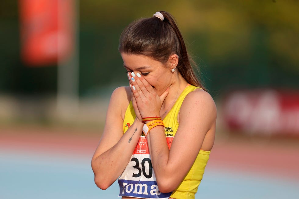 la atleta elba parmo se lleva las manos a la cara de la emoción celebrando el título de 100 metros vallas en el campeonato de españa de atletismo