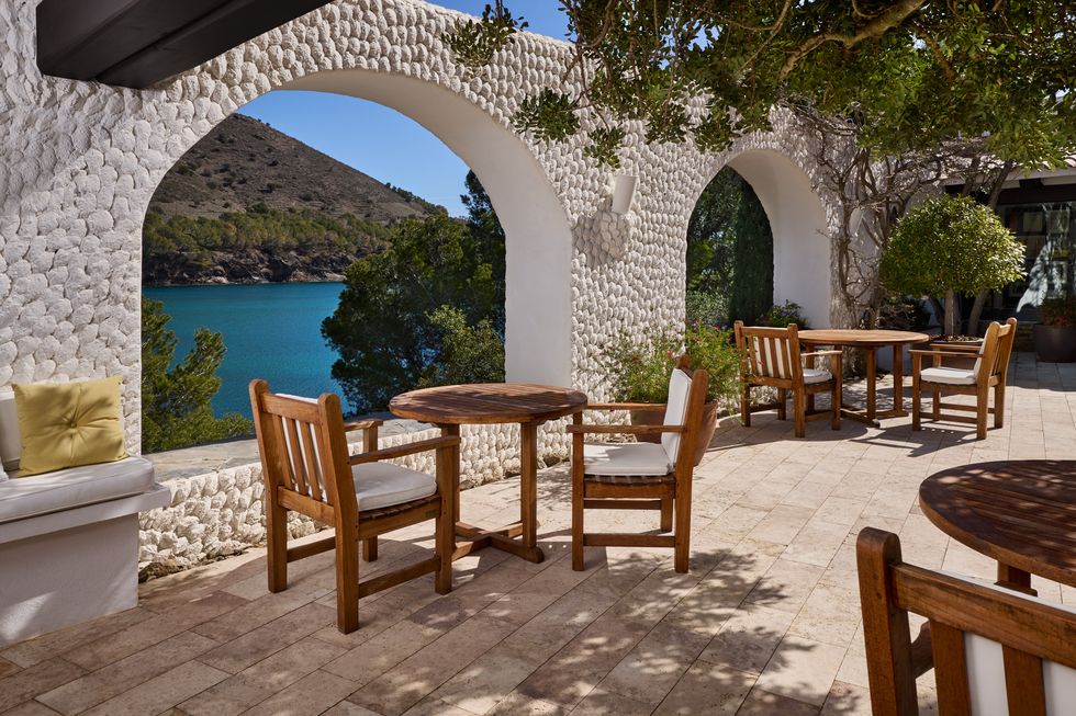 a patio with tables and chairs