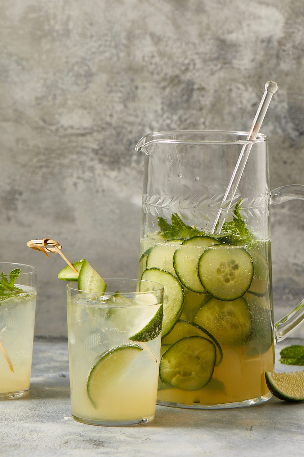 elderflower gin cocktail with cucumber slices in a pitcher