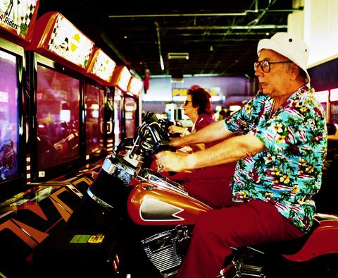 elderly man and woman on motorcycle arcade games