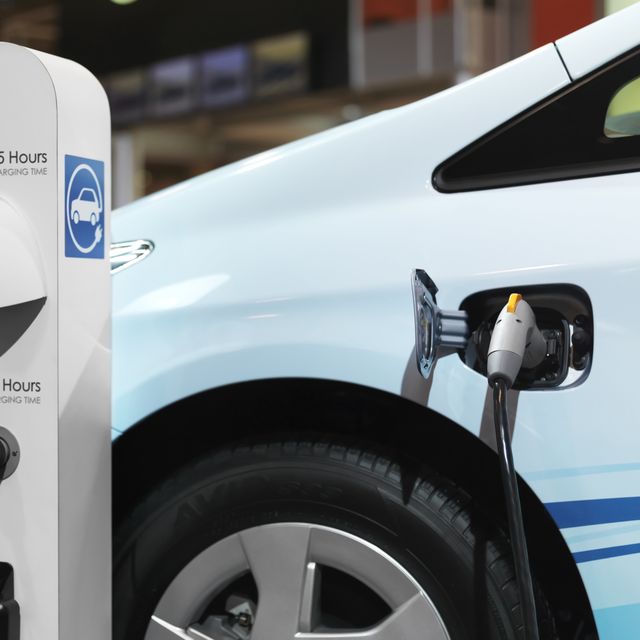 Electric car recharging batteries at a charging station