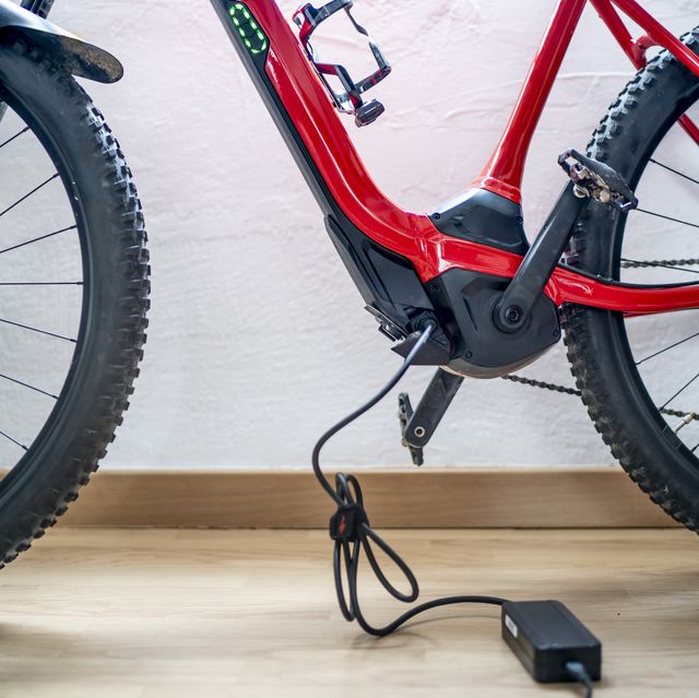https://hips.hearstapps.com/hmg-prod/images/electric-mountain-bike-charging-battery-next-to-royalty-free-image-1641931498.jpg?crop=0.668xw:1.00xh;0.221xw,0&resize=640:*