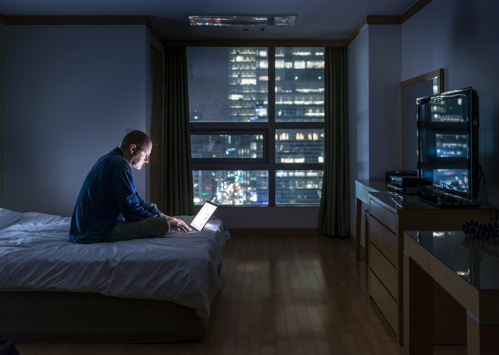 Man using laptop at night.