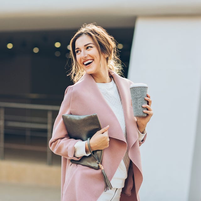 elegant woman walking outdoors and looking back