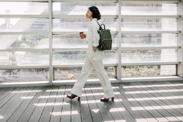 elegant woman walking to the office in the city downtown