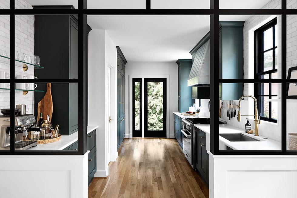 modern kitchen featuring a connection to a living space with a glass partition